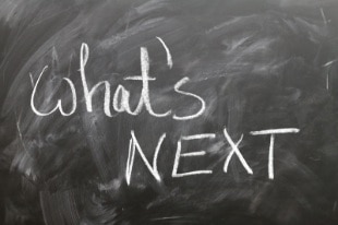 A blackboard with the message 'What's next' written on its surface using white chalk