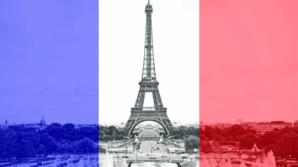 The Eiffel Tower in Paris shown against the backdrop of a French flag