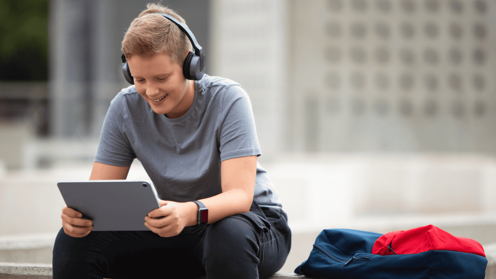 Teenager looking at laptop and smiling